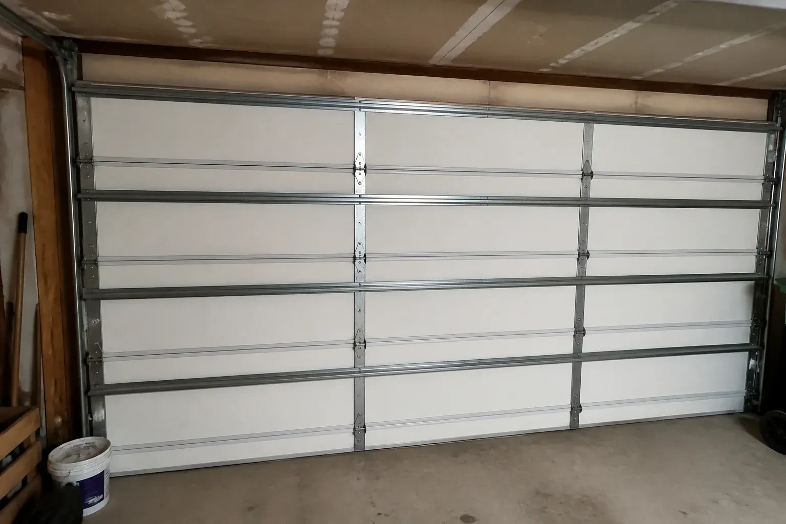 Interior of a closed sectional door with horizontal metal reinforcement struts. — Wind-Rated Garage Door Replacement, Kitchener
